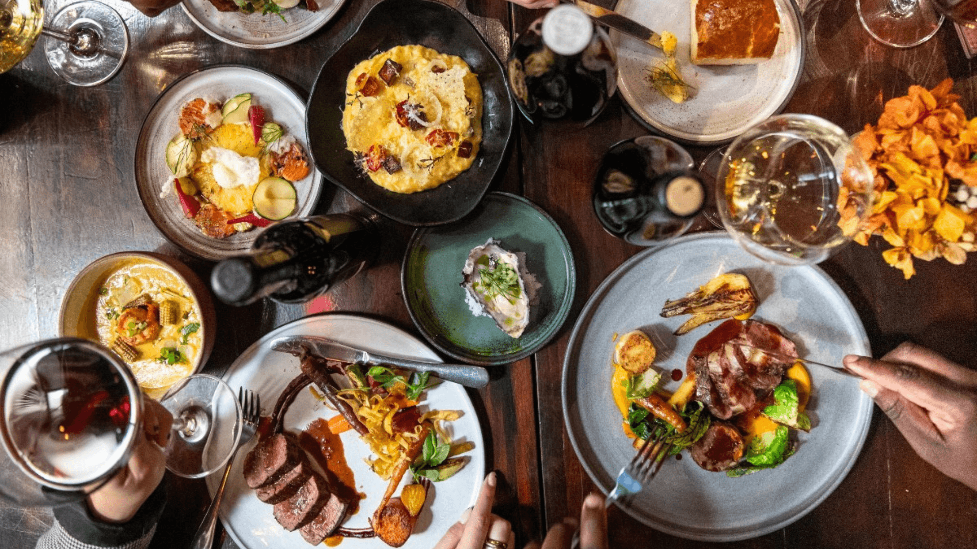 Plates of food and wine on a table.