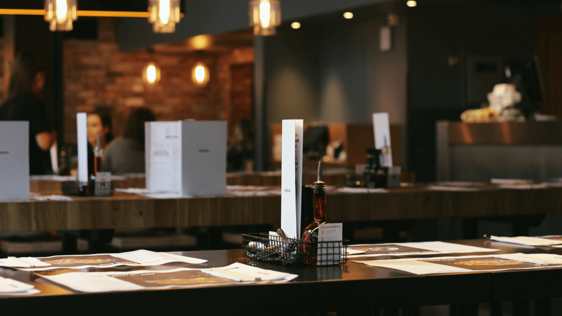 White menus on a wooden table.